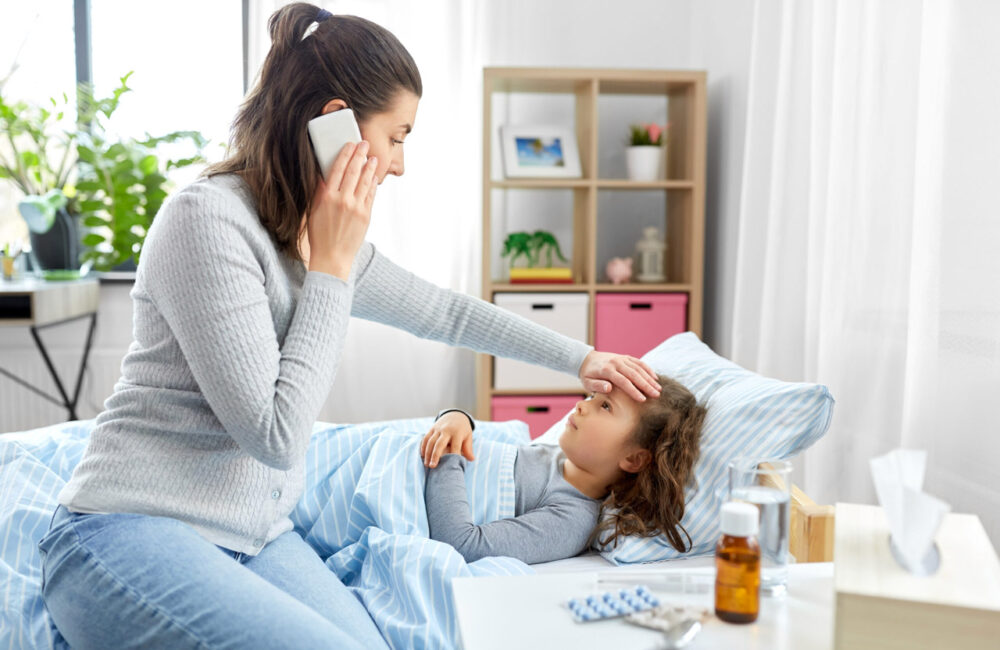 ill daughter and mother with smartphone calling doctor from home